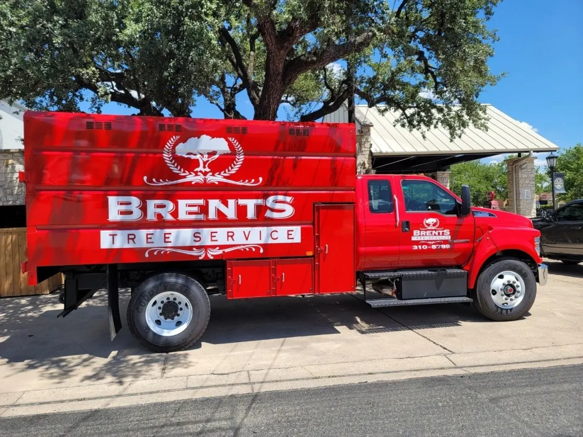 Bright red brents bucket truck on sunny day